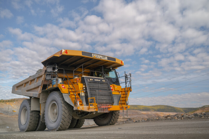 A number of CAT 777 mining trucks are working at the Malomyrsky mine
